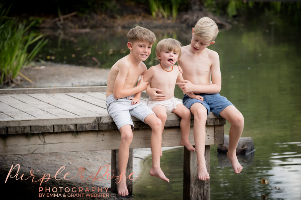 Brothers sitting on fishing platform