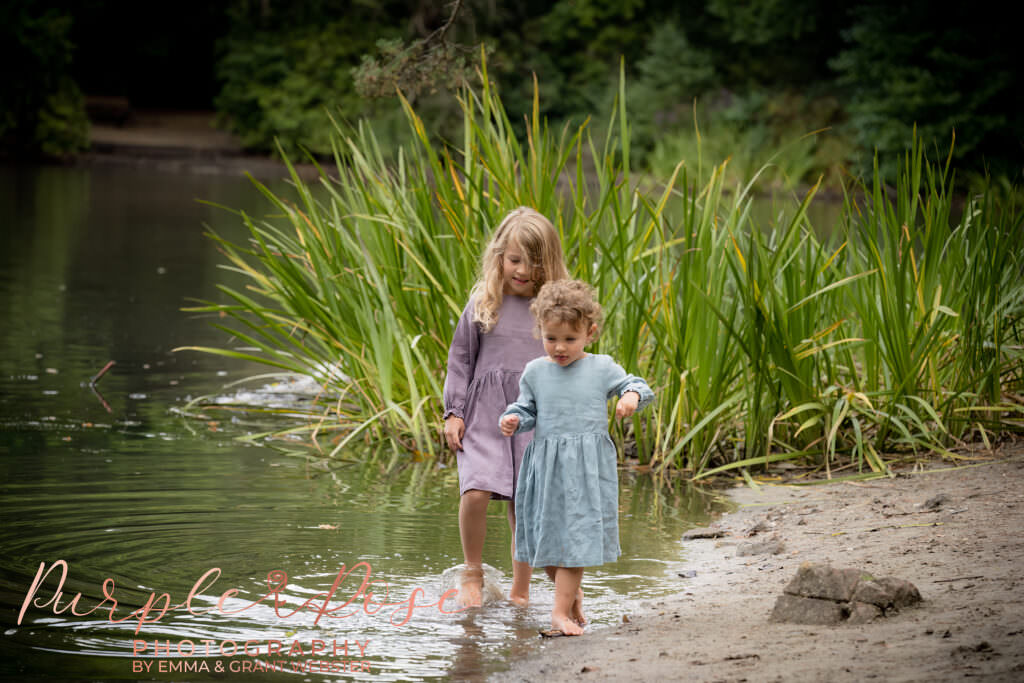Sisters walking in a river