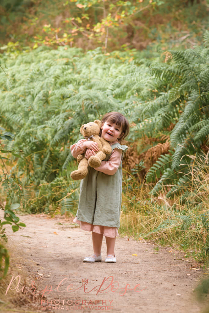 Girl hugging her teddy bear