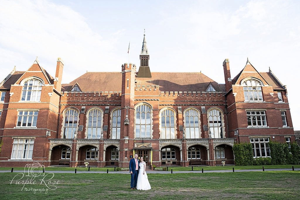 Bride & groom standing outside Bedford School