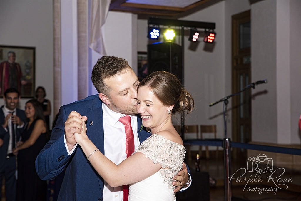 Groom kissing his bride