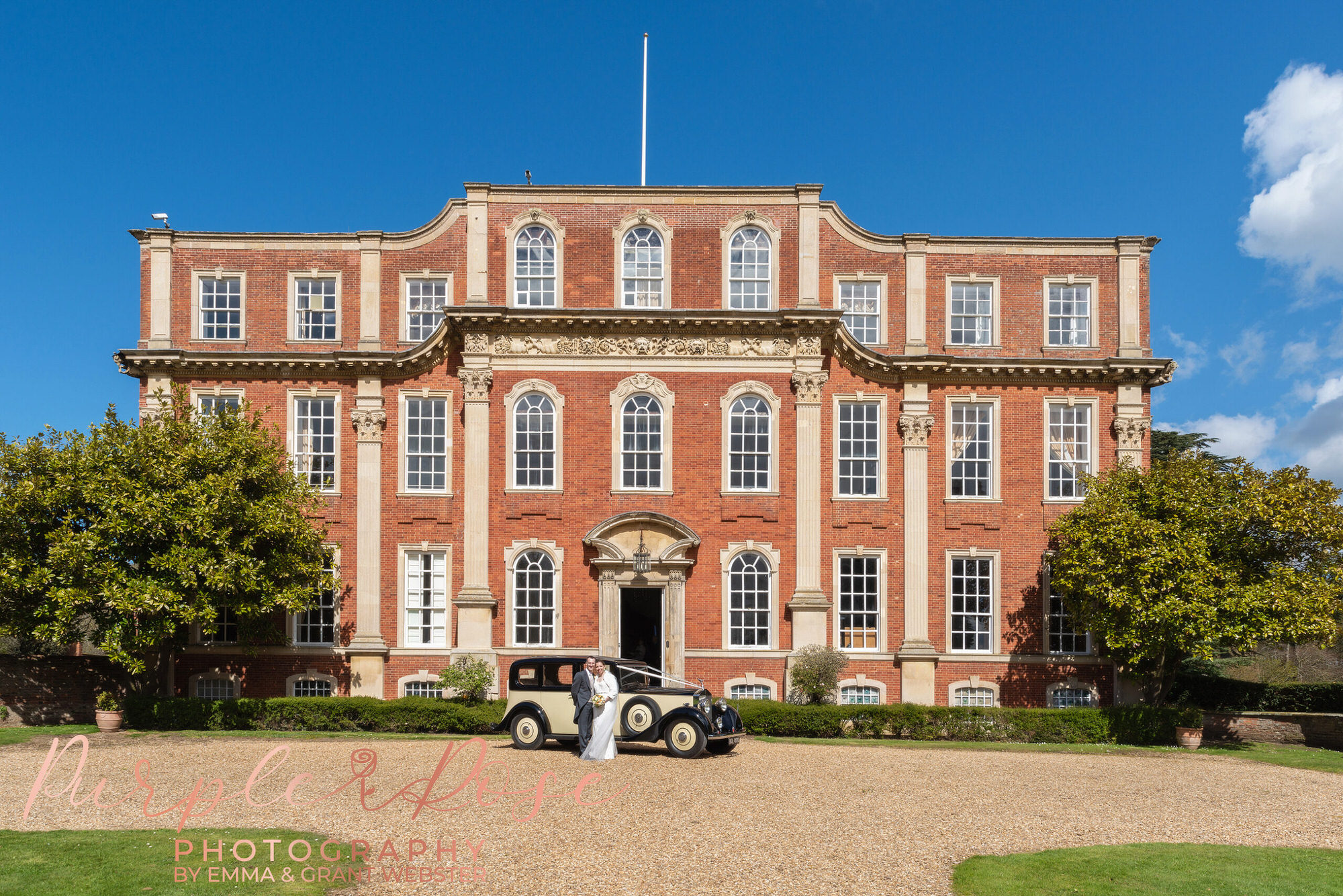 Bride and groom stood in fornt of Chicheley Hall In Milton Keynes