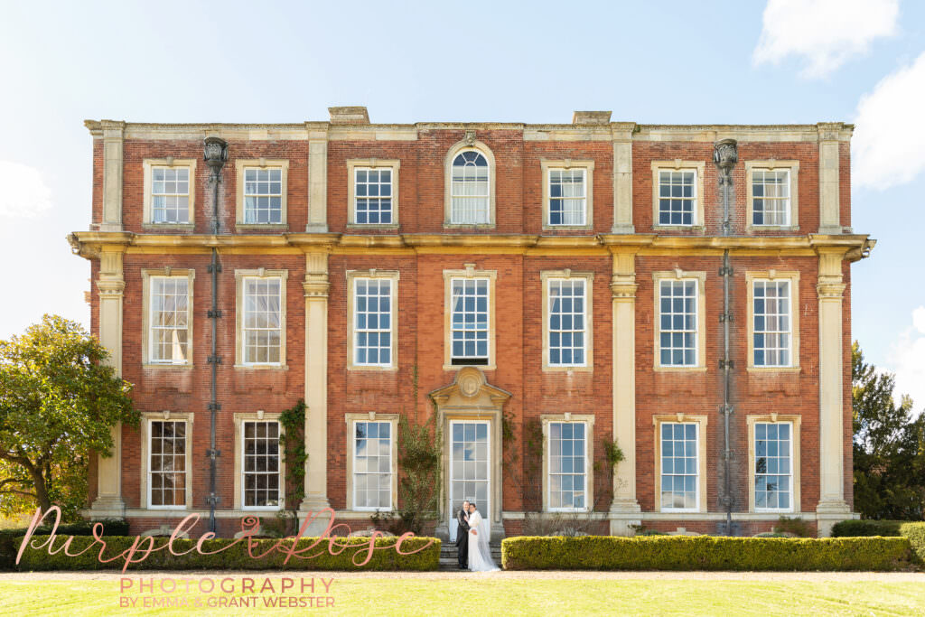 Photo of a bride and groom in fornt of their wedding venue in Milton Keynes