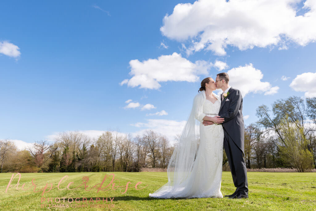 Photo of bride and groom kissing on their wedding day in Milton Keynes