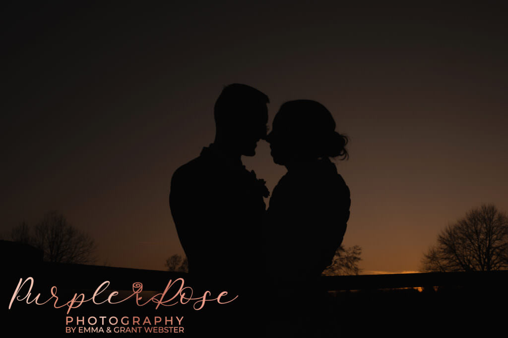 Silhouette of a bride and groom against a sunset on their wedding day in Milton Keynes