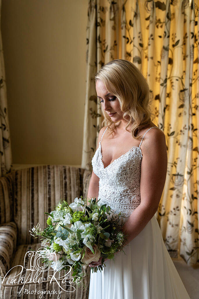 Bride looking at her bouquet