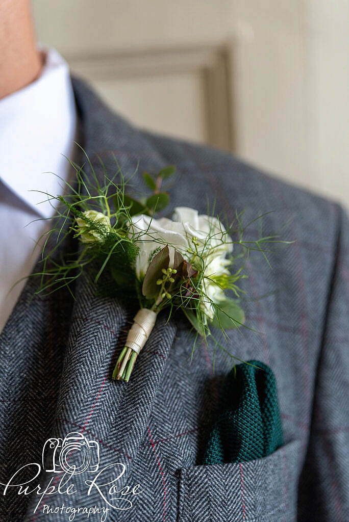 Groom wearing his button hole