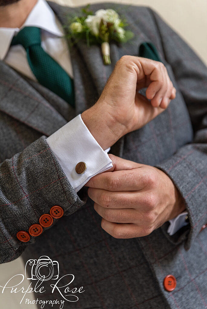 Groom adjusting his cufflinks