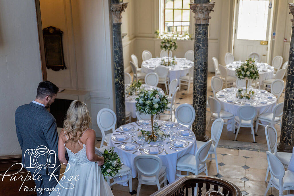 Bride and groom walking down staircase