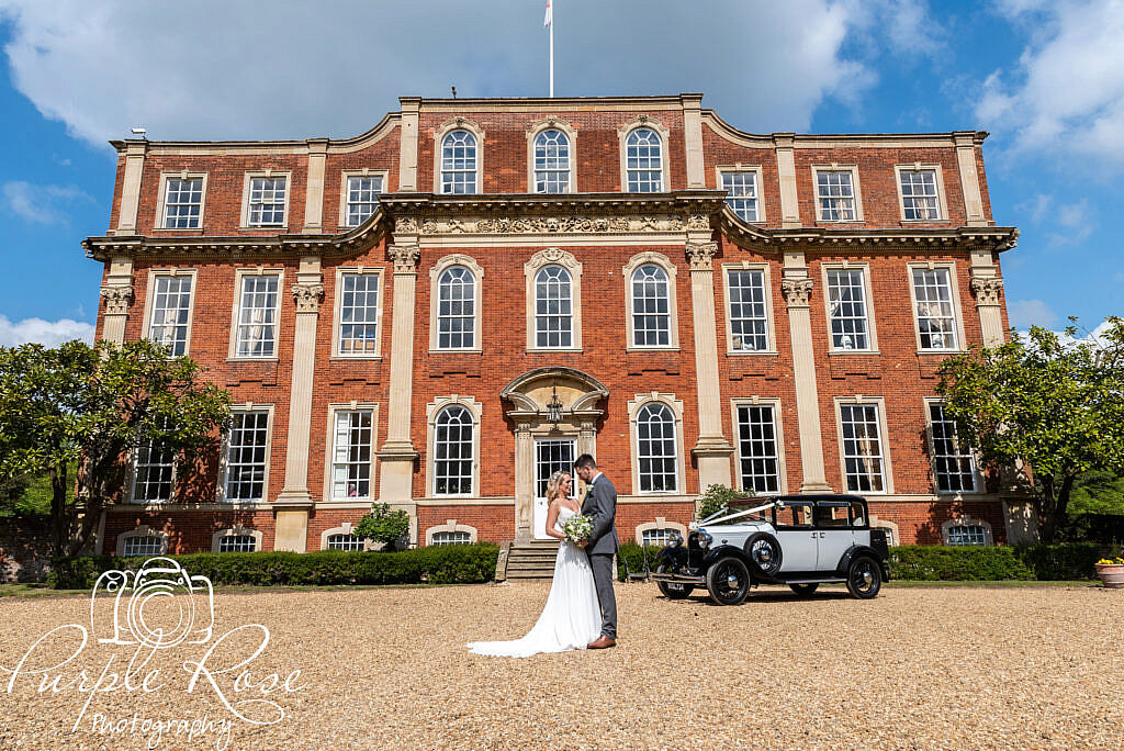 Bride and groom in fornt of their wedding venue