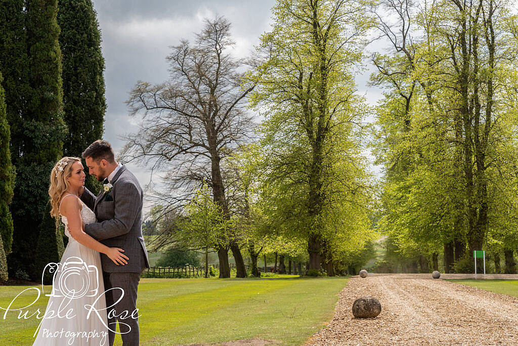 Bride and groom in the gardens of their venue