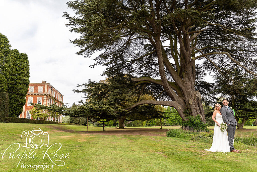 Bride and groom with Chicheley Hall in the background