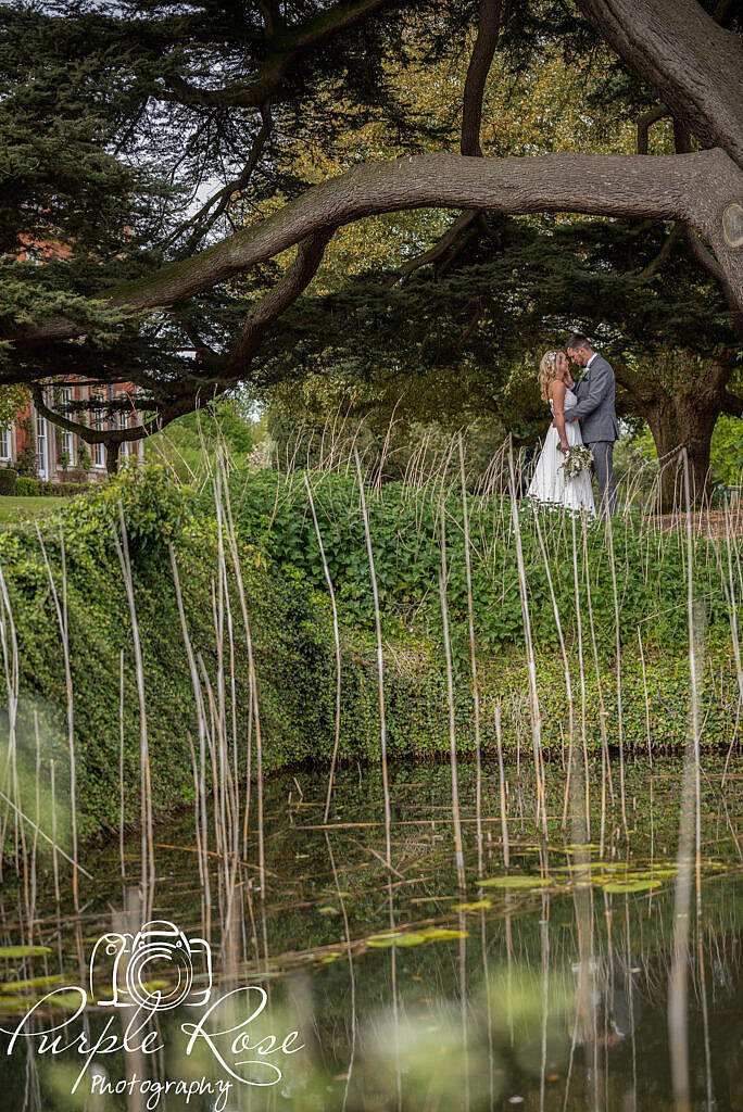 Bride and groom through reeds