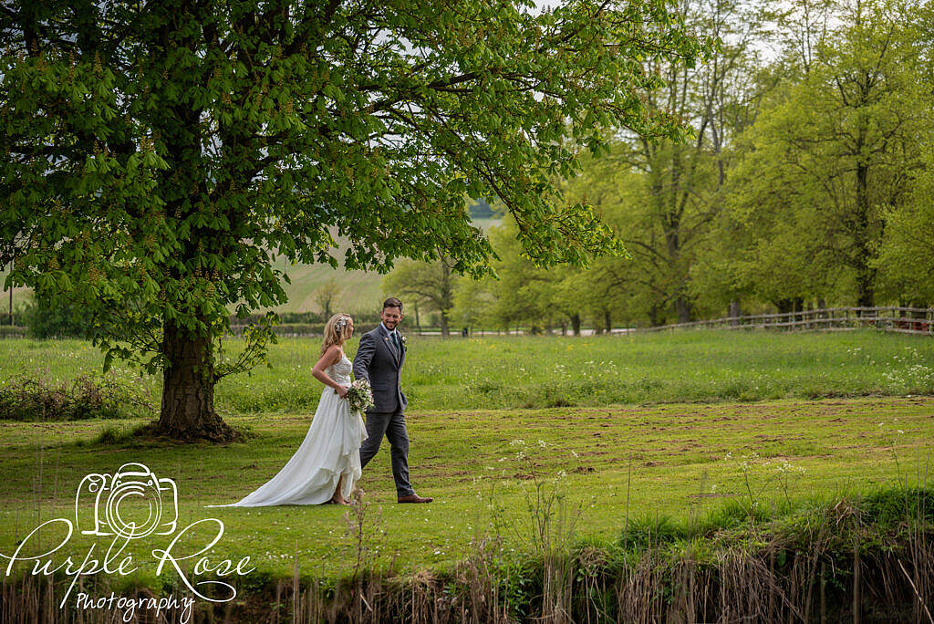 Bride and groom strolling through the gardens