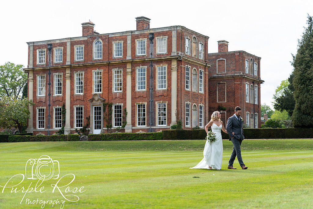 Bride and groom strolling round their venue