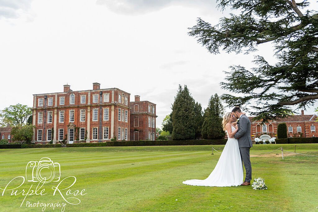 Bride and groom relaxing in their venues gardens