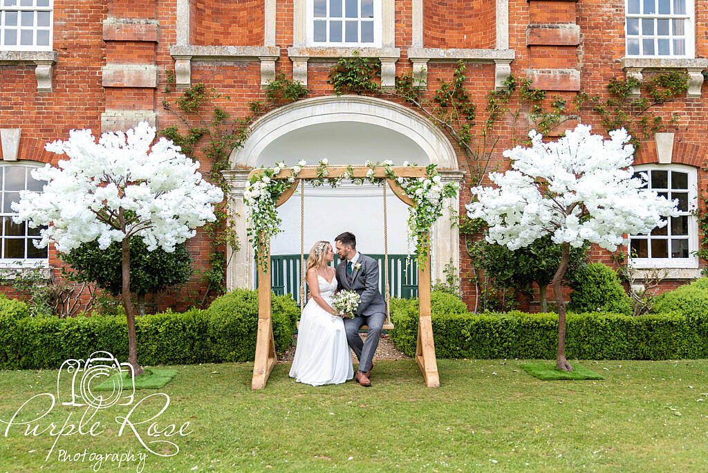 Bride and groom sitting on a swing