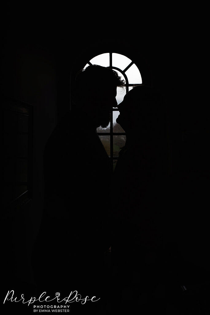 Silhouette of a couple in a window