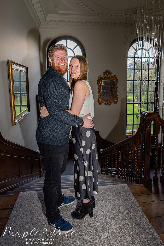 Couple embracing at the top of stairs