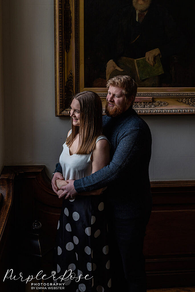 Couple looking out a window on staircase