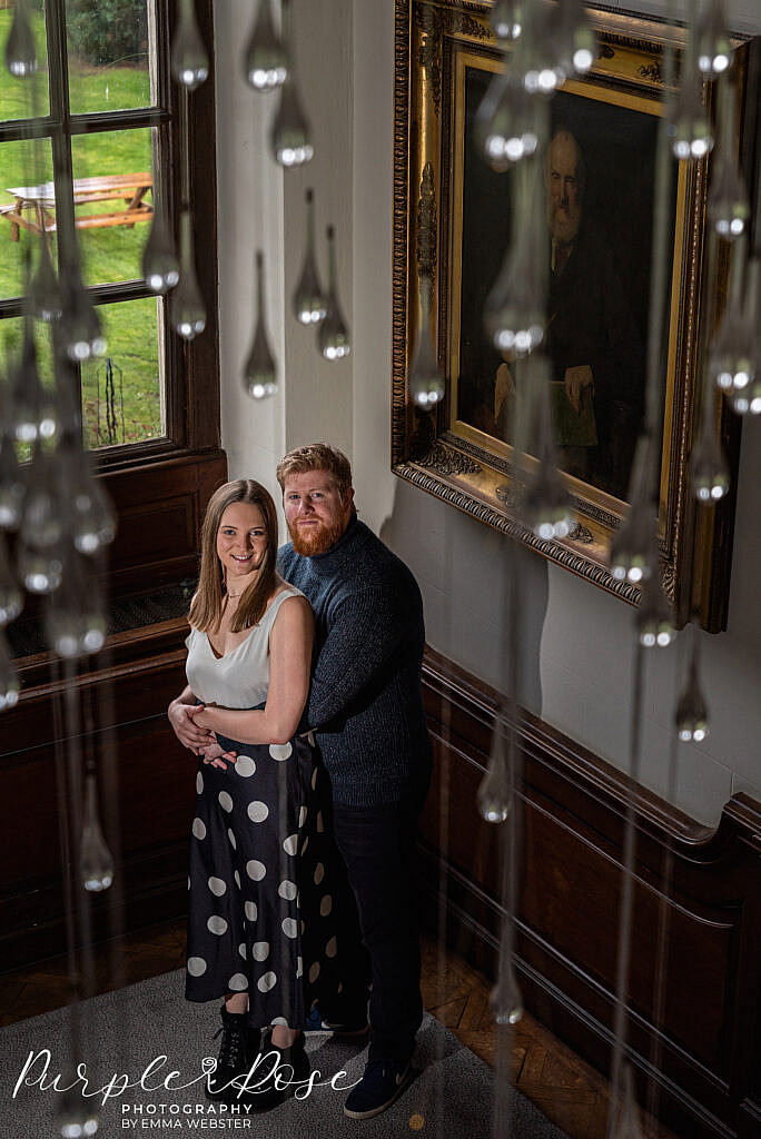 Couple standing by a window