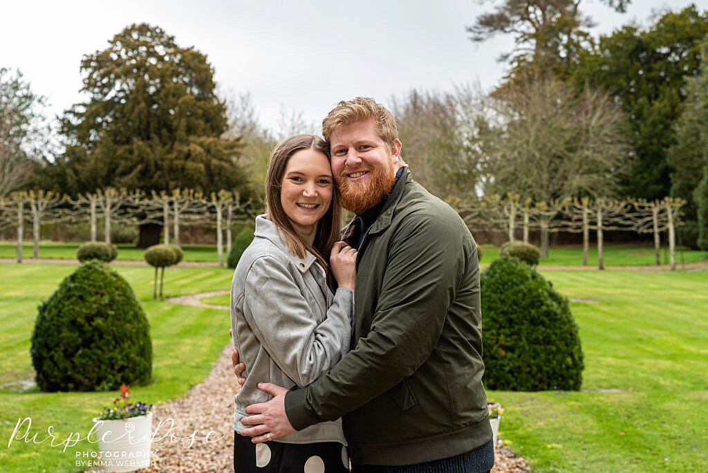 Couple embracing in a well kept garden