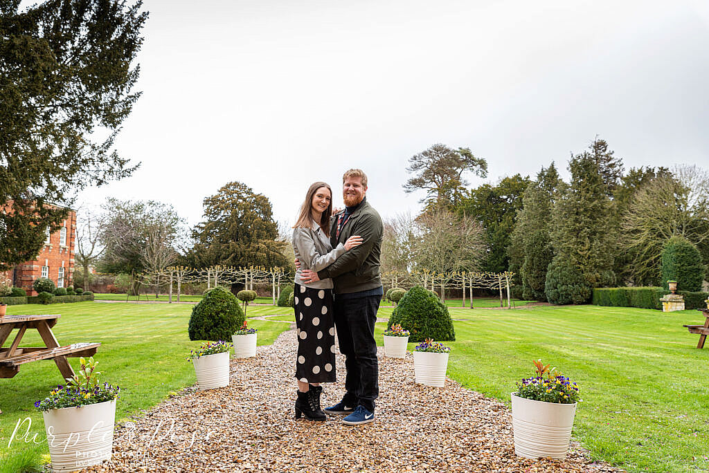 Couple hugging in a garden