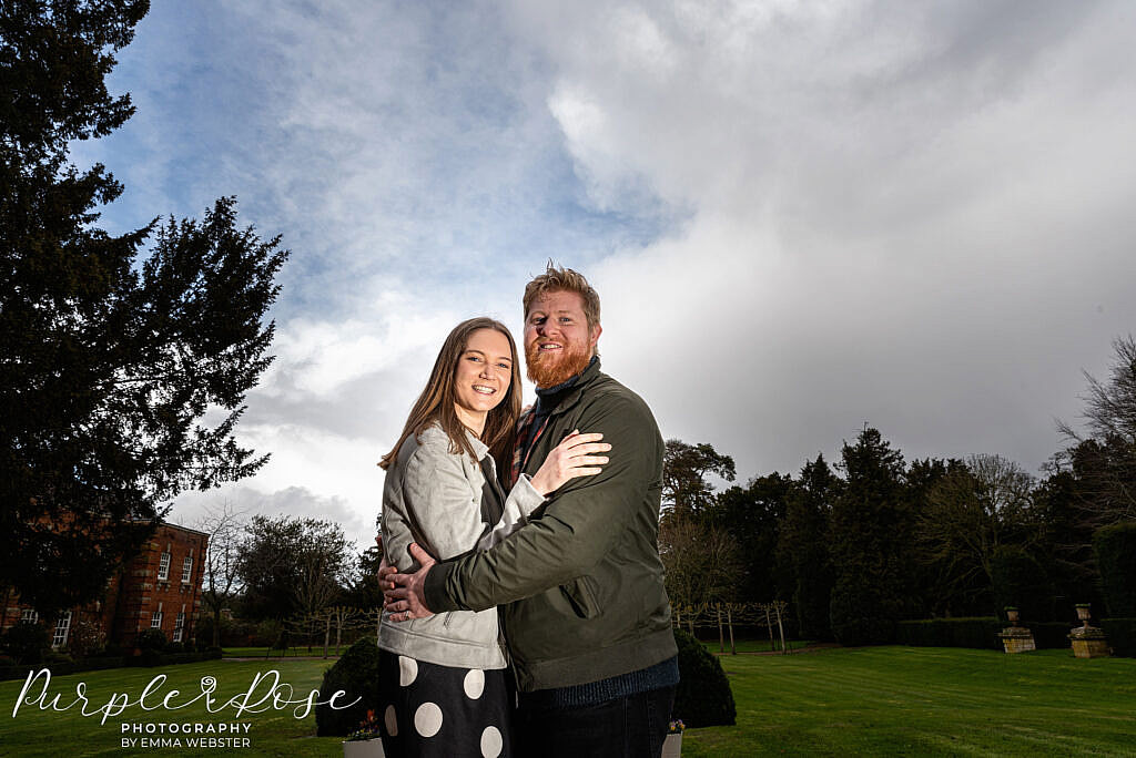 Couple standing in and English garden