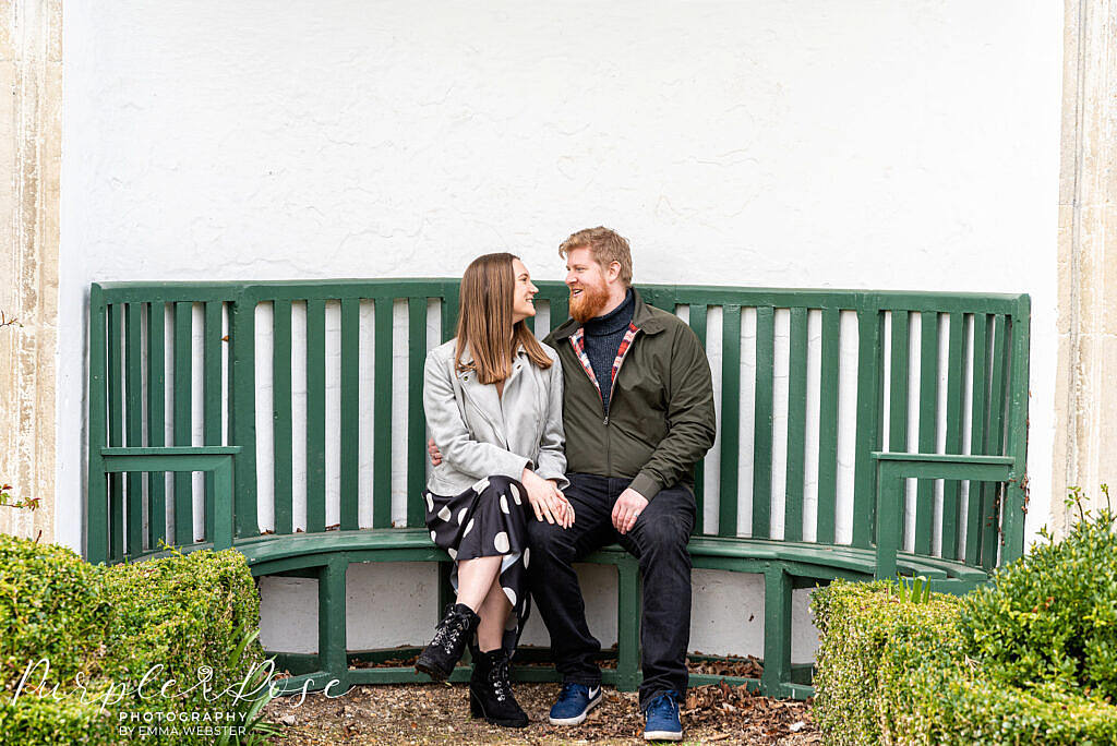 Couple sat on a green bench