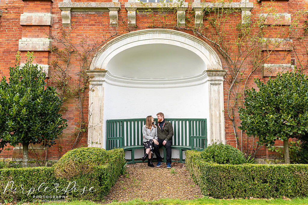 Couple sat on a green bench