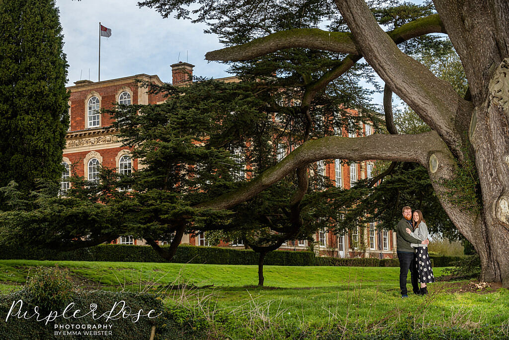 Couple standing by a tree