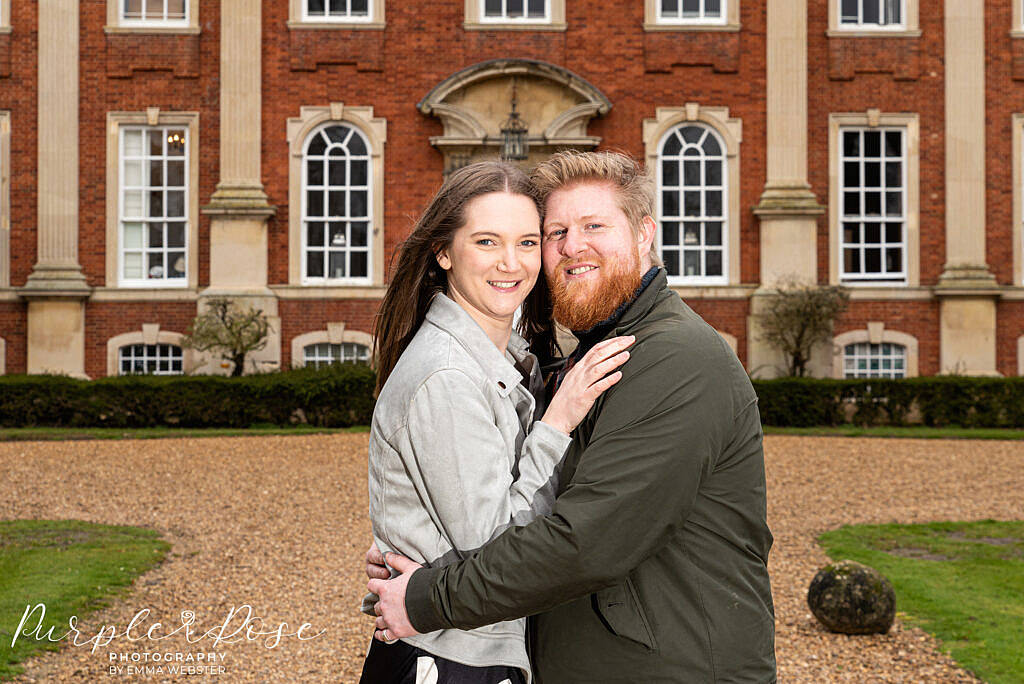 Couple hugging in front of Chicheley Hall