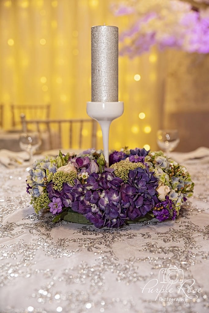Purple flowers and candle centre piece