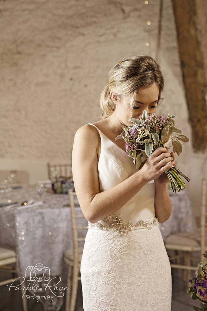 Bride smelling her bouquet