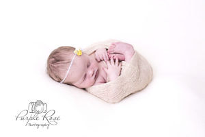 Newborn baby girl all wrapped up for her photshoot