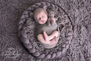 Newborn baby sleeping in a bowl