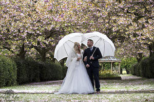 A couple enjoying the rain on their wedding day