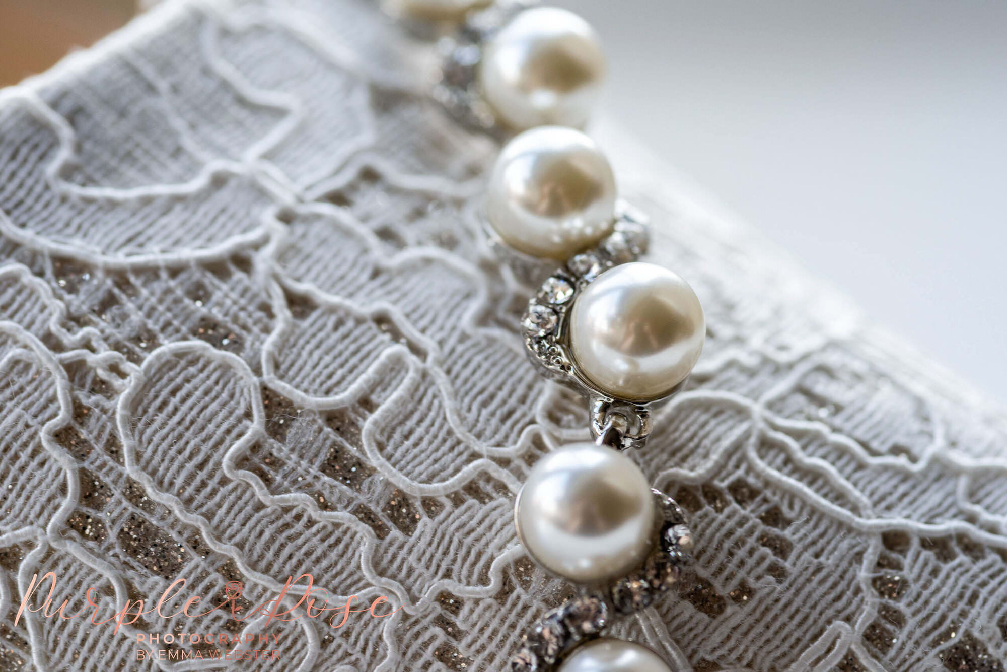 Pearl bracelet draped on lace shoes