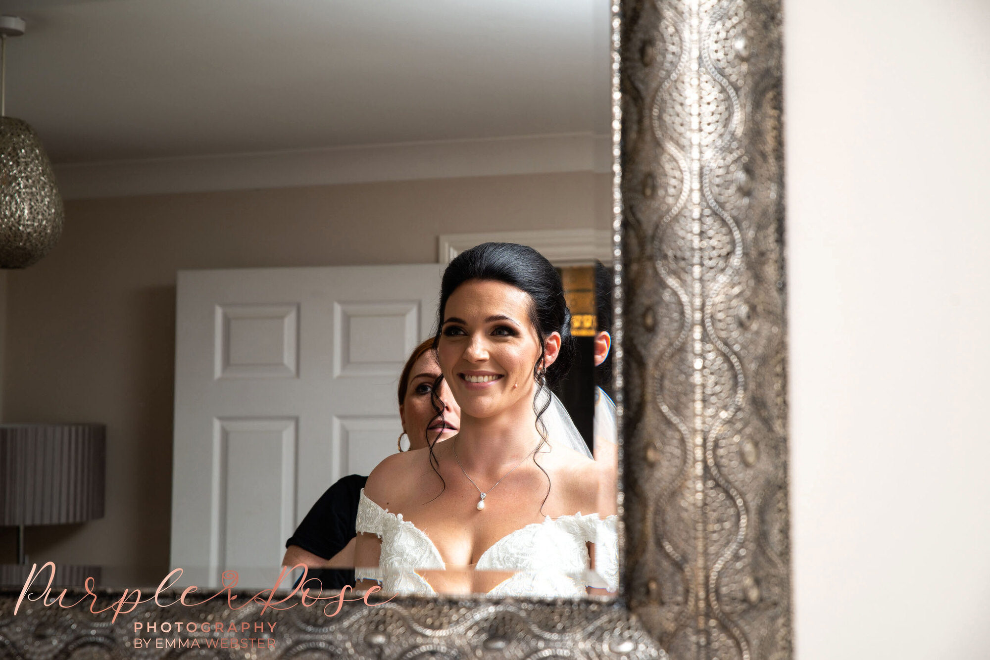 Bride looking at her hair and make-up in a mirror