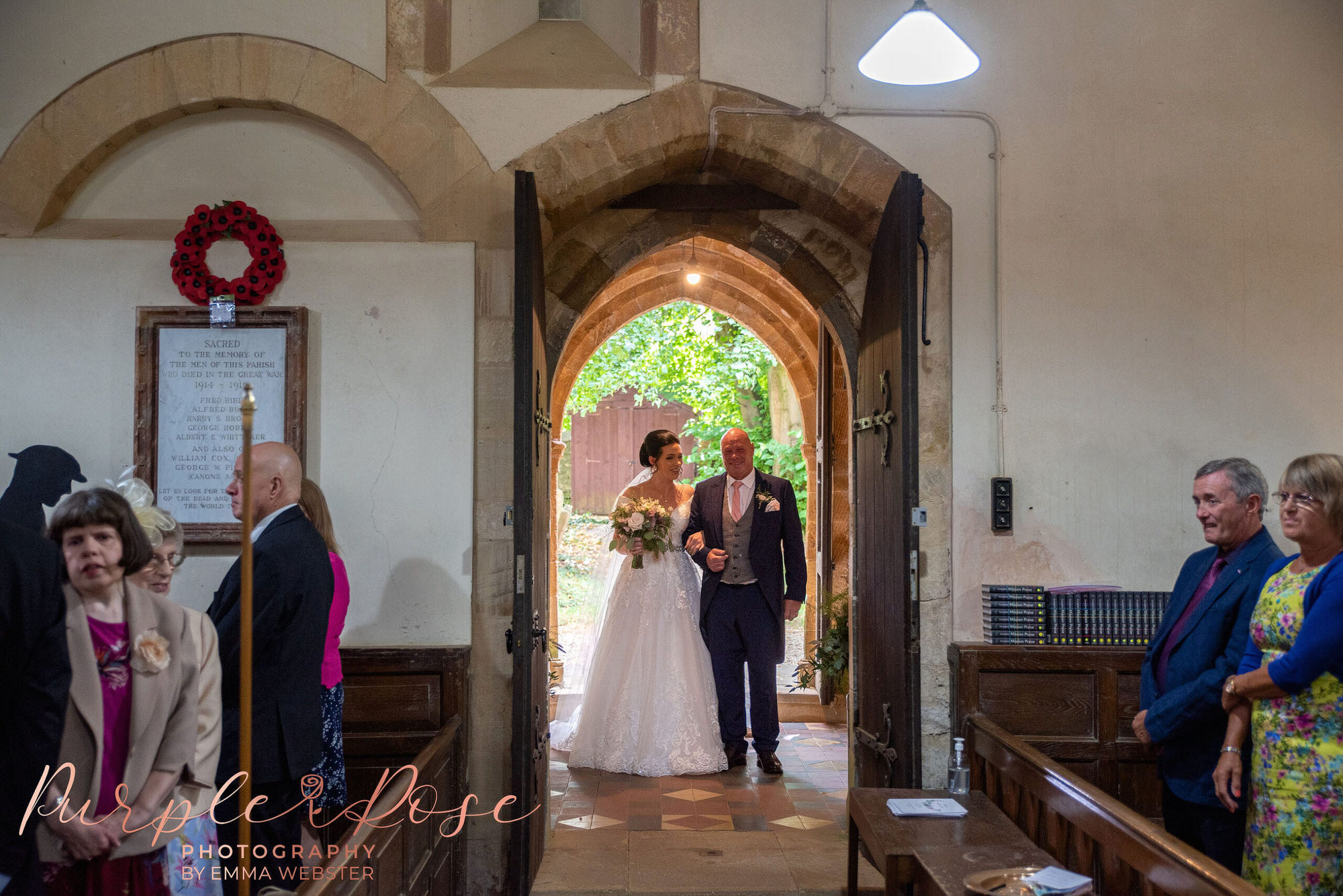 Bride waiting in the church doorway before her wedding ceremony