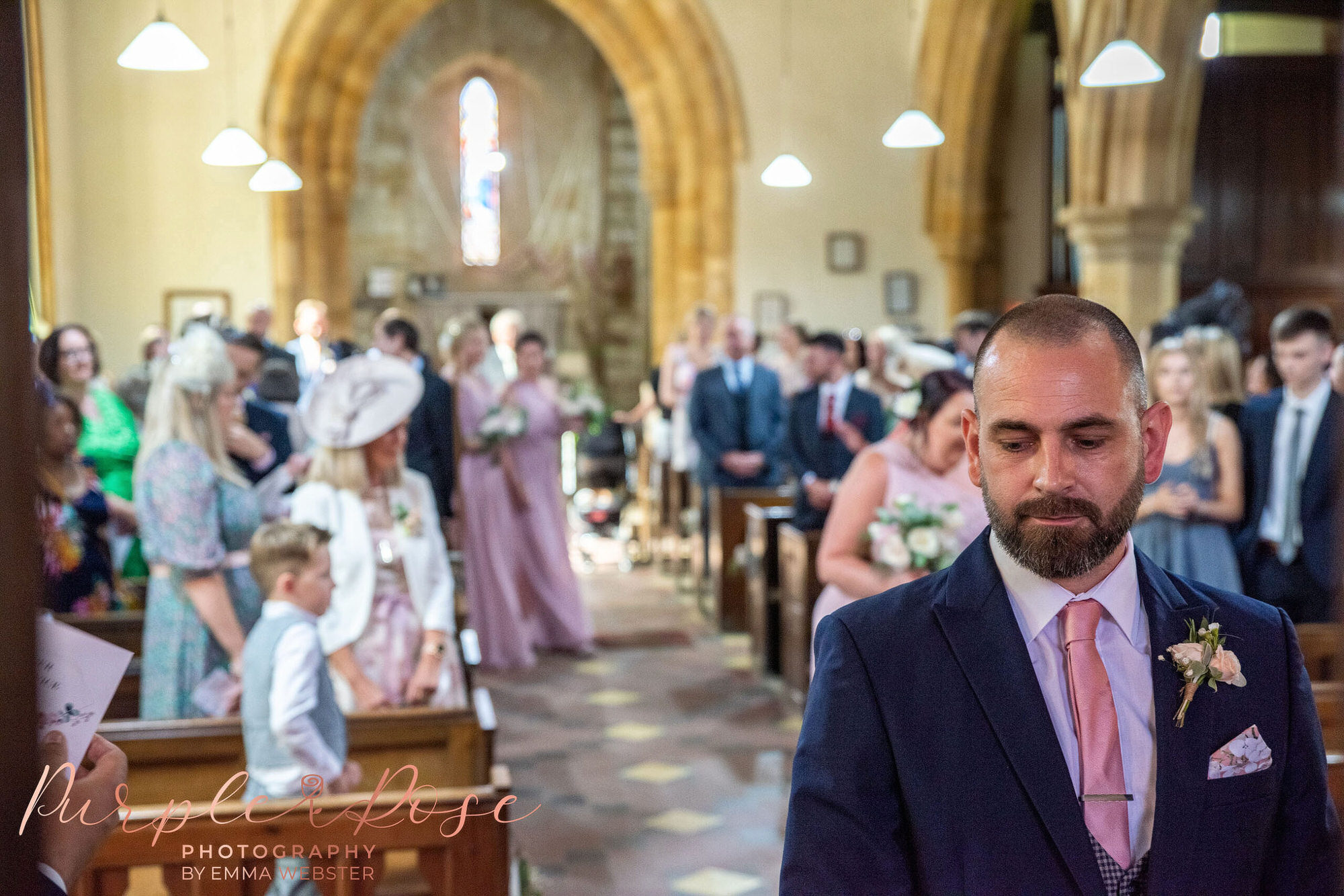 Bridesmaid walking towards groom in a church