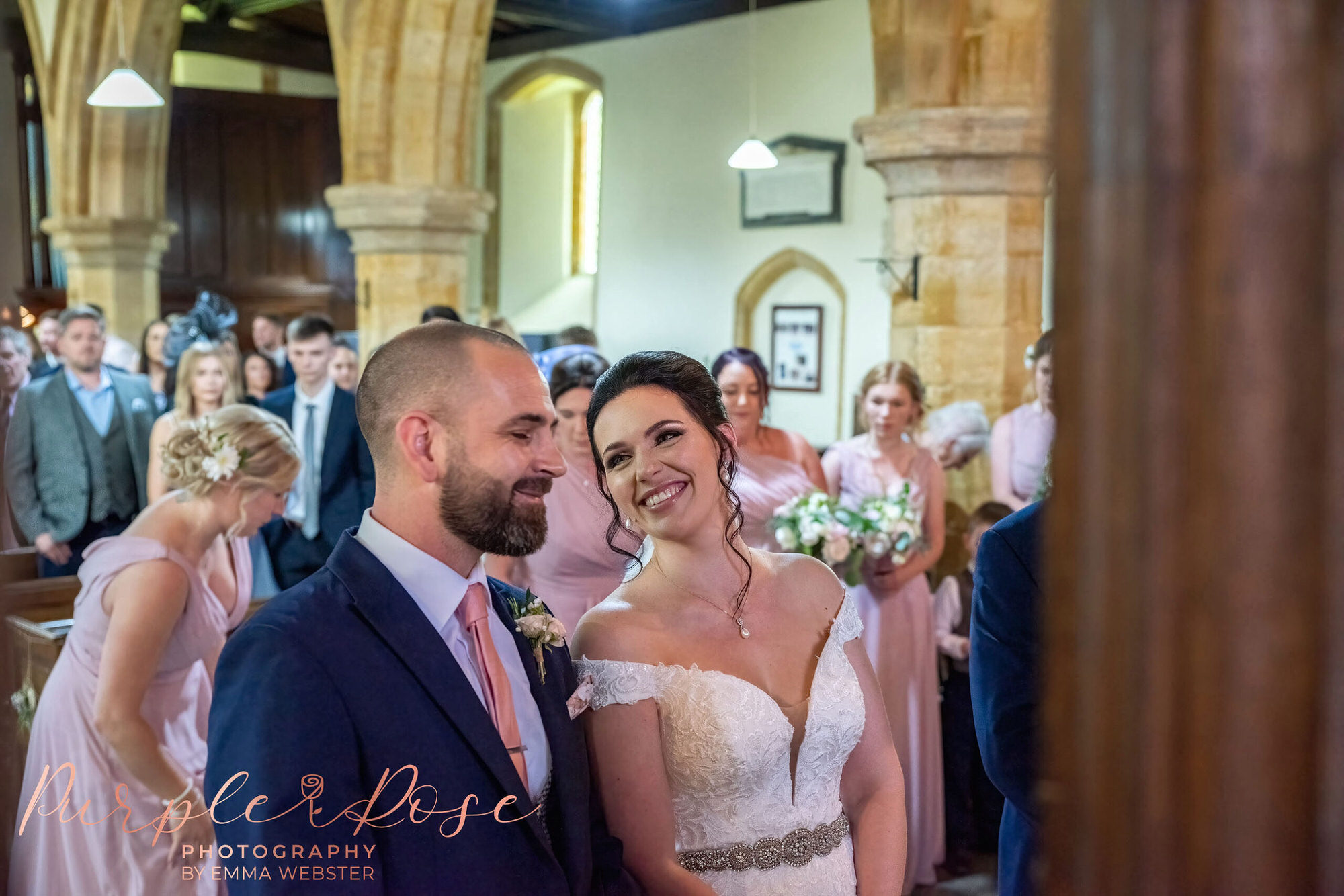 Bride smiling at groom during their wedding ceremony