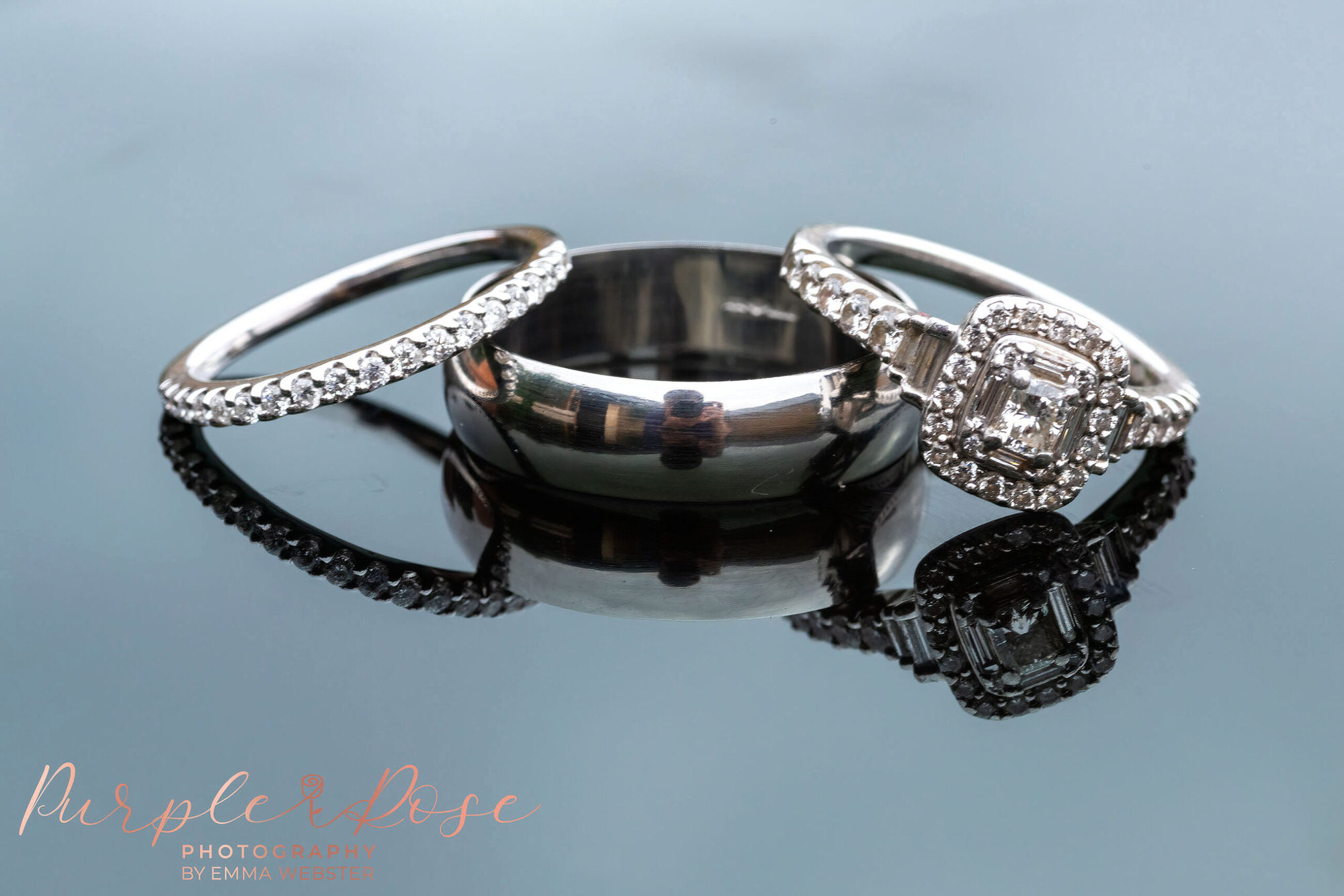 Weddign rings and engagement rings on a reflective surface