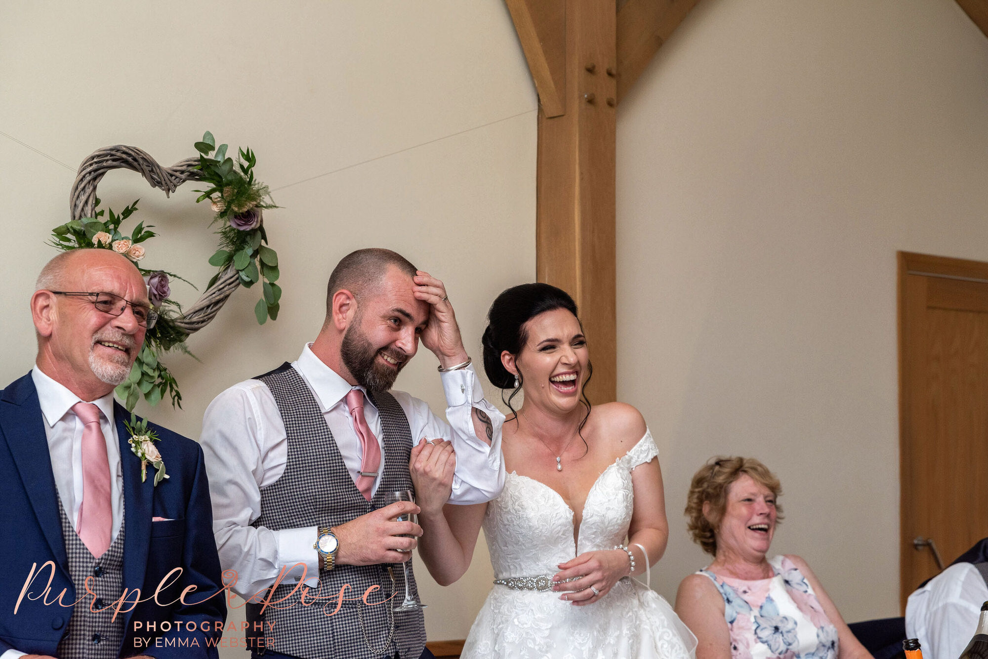 Bride and groom laughing during speeches