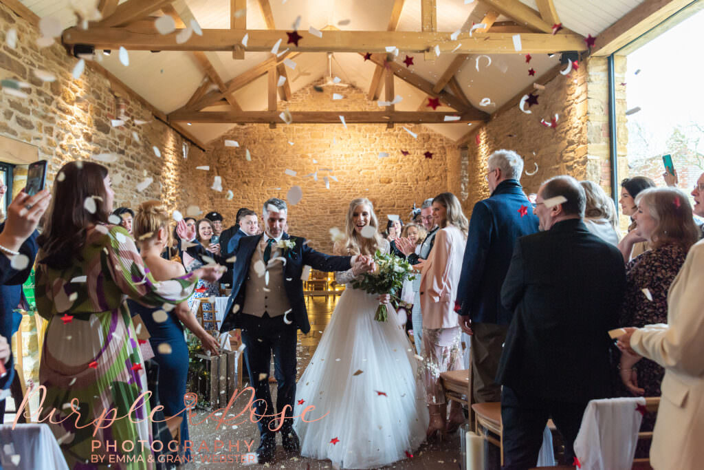 Photo of a bride and groom leaving their wedding ceromny in Milton Keynes