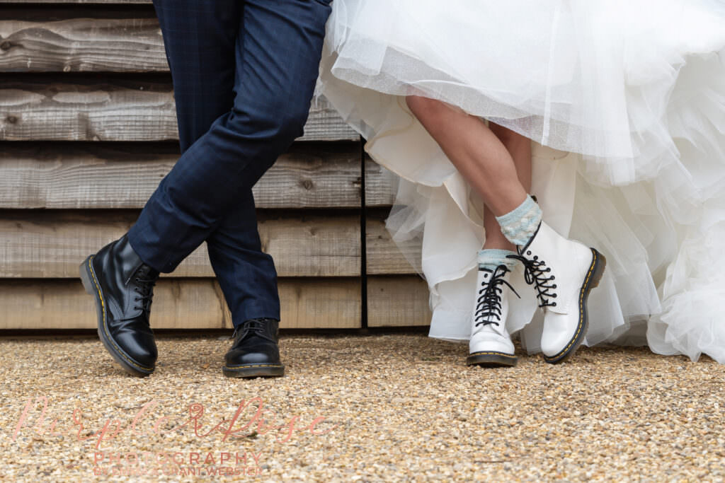 Photograph of a bride and grooms feet wearing Doc Martin shoes on their wedding day in Milton Keynes
