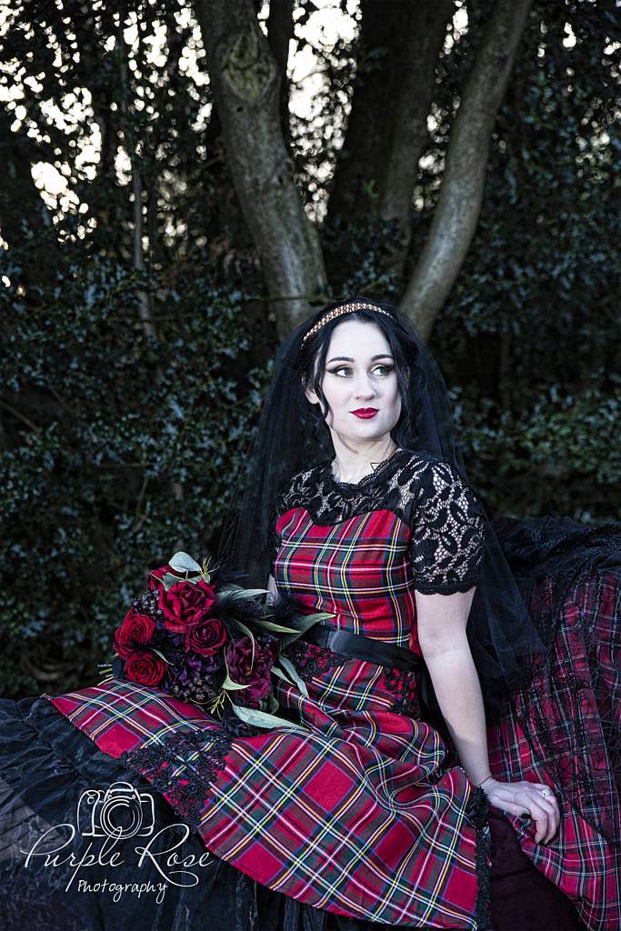 Gothic bride wearing red tartan dress