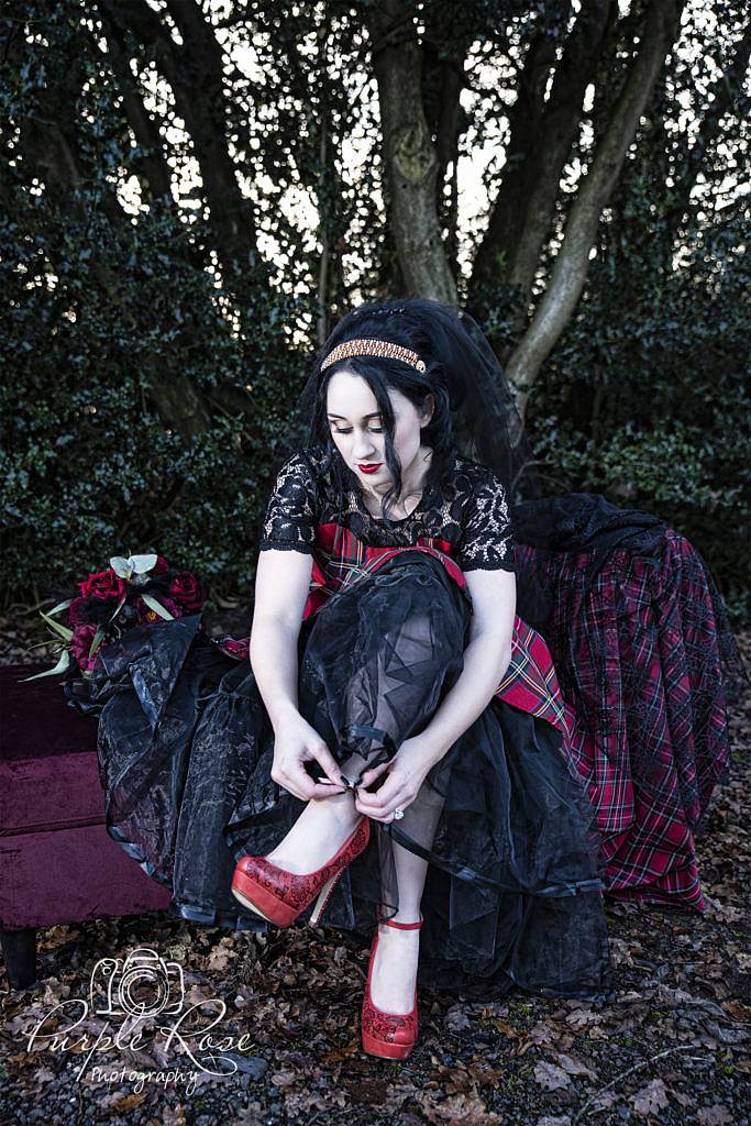 Gothic bride wearing red tartan dress