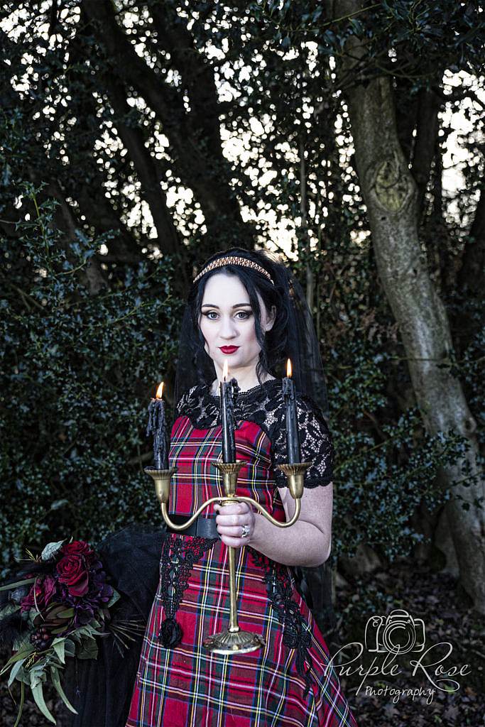 Gothic bride holding candle stick