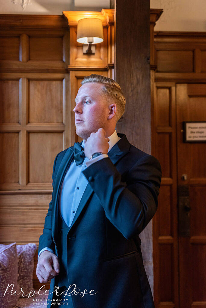 Groom adjusting his shirt